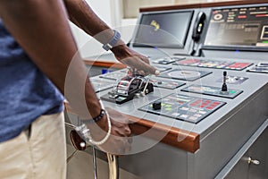 Captain`s hands at the helm of a boat