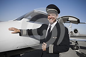 Captain Standing By Aircraft At Airfield photo