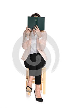 Captivated smart casual woman reading while sitting