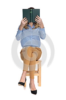 Captivated smart casual woman reading while sitting