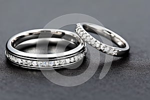 Captivating close up shot of two wedding rings, delicately intertwined to symbolize the everlasting bond of love and commitment.