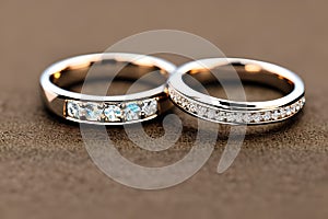 Captivating close up shot of two wedding rings, delicately intertwined to symbolize the everlasting bond of love and commitment.