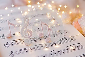Enchanting Musical Notes and Treble Clef Adorned with Glimmering Fairy Lights on Sheet Music
