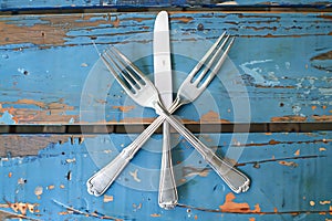 Rustic Charm: Elegant Cutlery on Weathered Blue Wood photo