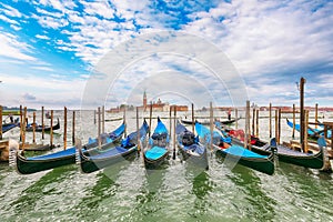 Captivating landscape with Church of San Giorgio Maggiore on background and gondolas parked beside the Riva degli Schiavoni in