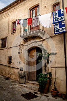 Captivating Photo of a Typical Italian Street Balcony with Clean Laundry in Rocca Imperiale