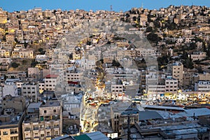 Captivating skyline of Amman, Jordan traditional houses atop a picturesque hill during blue hour