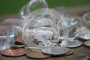 Captivating Still Life Composition Featuring Artfully Arranged Ice Cubes and Coins on a Vintage Wooden Table, Perfect for Retro-