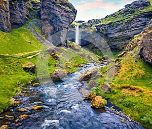 Captivating sunrise view of Kvernufoss watterfall. Superb summer scene of pure water river in Iceland, Europe. Beauty of nature co