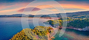 Captivating sunset on Saint Basil Beach with Agkali village on background, Nileas, Greece, Europe.