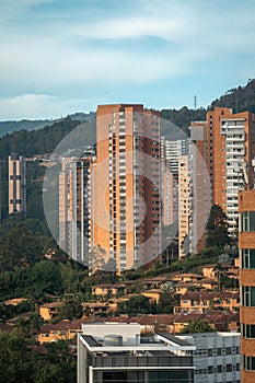 vertical capture of el poblado medellin colombia during the day with many buildings and residential spaces in frame photo