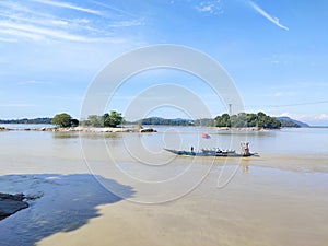 Captured far image of an Umananda Temple  & a boat with fisherman