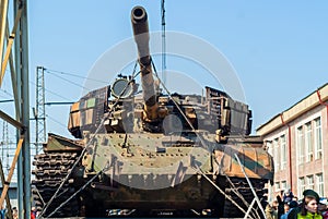 Captured tank of terrorists with artisanal reactive armor on a railway flatcar