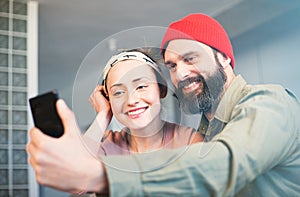 Capturing happy moments. Beautiful young loving couple bonding to each other and making selfie while sitting on the