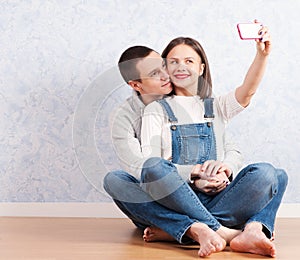 Capturing happy moments together. Happy young loving couple making selfie photo