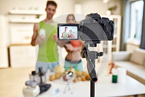 Capturing ideas for Life. Young couple recording video blog or vlog about their nutrition on camera at home. Man and