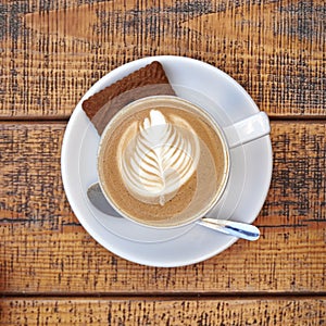 Capuccino cup on wooden background