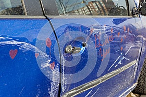 Car after accident, blue car crashed, accident,.Scratched doors, side of a blue female car with the words