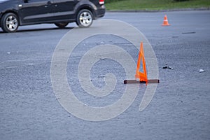 Car accident in the city. Emergency sign on the asphalt