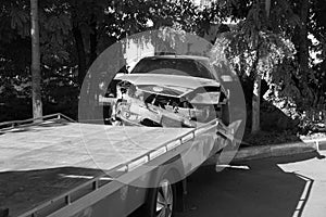 Car accident, head-on collision. Tow truck loads a wrecked car after an accident