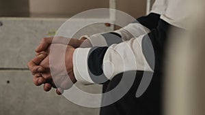 Car accident participant waiting for alcohol test police station, hands closeup