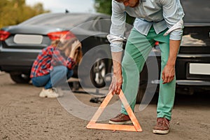 Car accident on road, male and female drivers