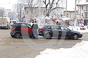 Car accident on a road covered with low amount of snow