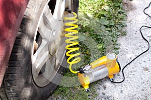 Car air compressor with yellow twisted hose