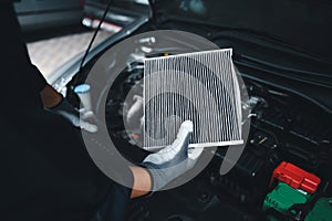 Car air conditioner system maintenance, Hand mechanic holding car air filter to check for clean dirty or fix repair heat have a