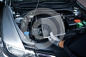 Car air conditioner system maintenance, Hand mechanic holding car air filter to check for clean dirty or fix repair heat have a