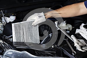 Car air conditioner system maintenance, Hand mechanic holding car air filter to check for clean dirty or fix repair heat have a