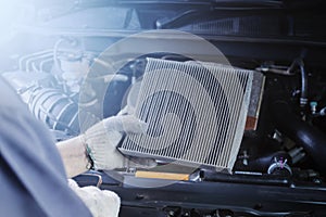 Car air conditioner system maintenance, Hand mechanic holding car air filter to check for clean dirty or fix repair heat have a