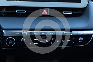 Car air conditioning button inside a car. Modern car climate control panel for driver and passenger with shallow depth