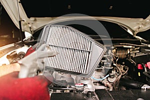 Car air filter cleaning with air blow gun.