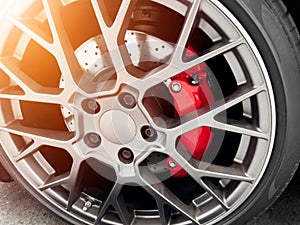 Car alloy wheel and tyre. New alloy wheel with tire and red carbon ceramic brakes. Alloy rim. Car wheel disc. Car spare parts