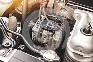 Car alternator in benzine engine,  component of the electrical charging system of the car engine photo