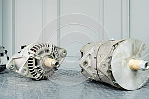 Car alternators on display on metal shelf/auto parts