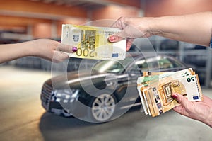 Car as background for female hands with euro banknotes