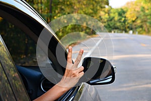 Car on asphalt road in nature with Hand