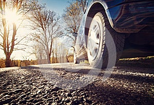 Car on asphalt road in spring morning