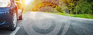 Car on asphalt road in summer