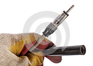 A car audio connector or trailer for closing an electrical circuit that a mechanic holds in gloves during repairs