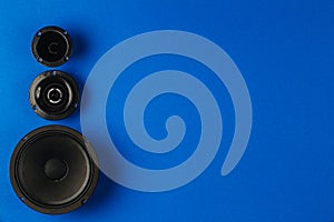 Car audio. Car speakers, bass speaker and midrange speaker lie in a row