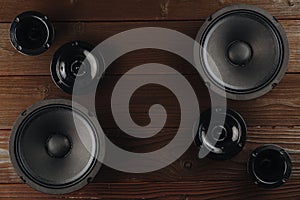 Car audio system. A set of speakers on a wooden brown background