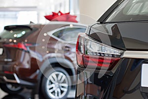 Car auto dealership. Themed blur background with bokeh effect. New cars at dealer showroom.