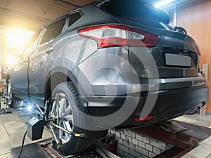 Car in auto service. Sensors on SUV wheels check alignment camber toe. Work with chassis and suspension of car