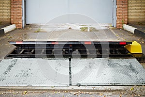 Car barrier (roadblock) in front of metal