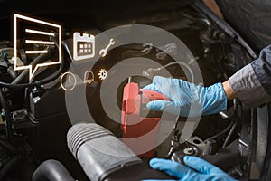 Car battery care, Mechanic checking battery.
