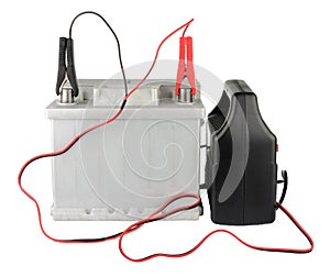 Car battery with two jumper cables clipped to the terminals isolated on white photo