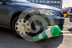 Car bending white and green safety traffic post with front bumper, wrong parking, car insurance, fine, penalty